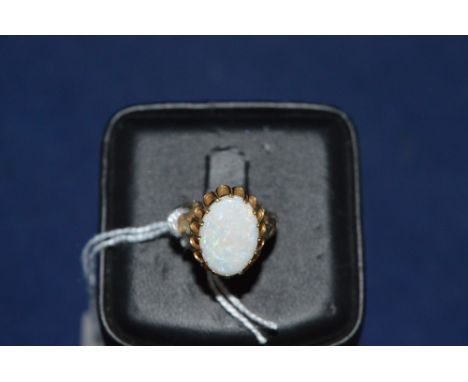 White opal ring, on 9ct yellow gold shank, ring size N.