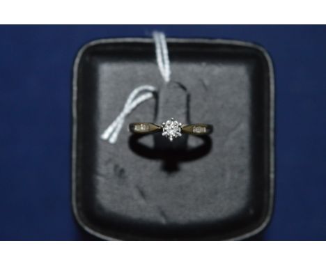 Diamond ring, in illusion setting flanked by diamond shoulders, on 9ct yellow gold shank, ring size L.