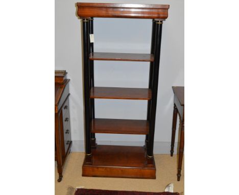 A reproduction mahogany five-tier floor-standing display shelf unit, the top tier with shaped frieze supported by four turned