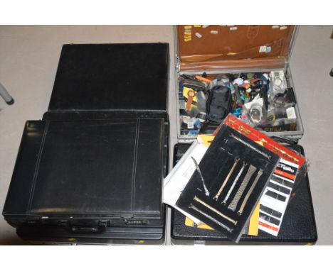 Five briefcases containing assorted digital watches; watch straps; and batteries (one case locked).