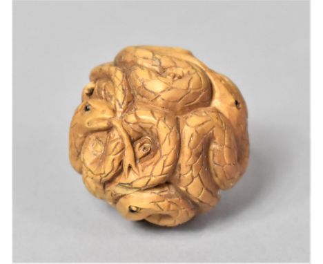A Carved Wooden Netsuke of a Ball of Snakes with Glass Eyes 