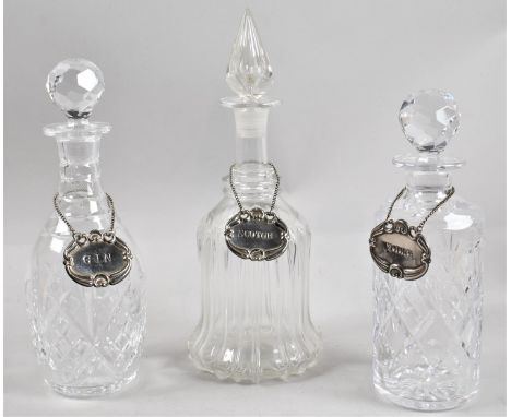 A Collection of Three Decanters with Silver Plated Gin, Scotch and Vodka Labels 