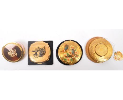A group of vintage mid 20th Century compacts. The lot to include a Kigu compact with photo compartment, a Kigu butterfly comp