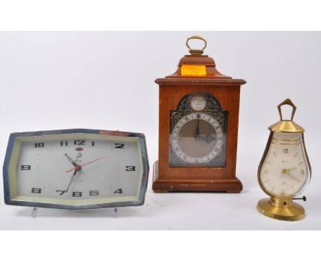 A collection of three vintage retro mid 20th century clocks to include a Swiza eight jewels clock in brass lantern shaped cas