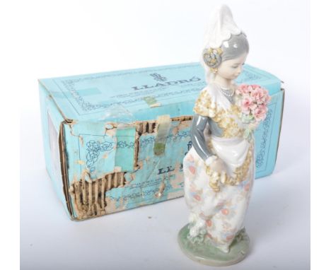 Lladro - A vintage 20th century Spanish porcelain Lladro figurine 'Valencian Girl with Flowers'. No 1304. In original box.