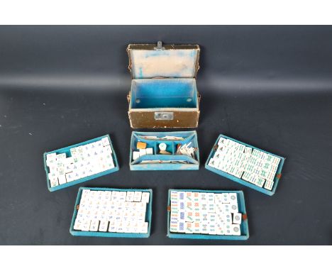 A 20th Century circa 1930's Chinese Mah-jong set. With bone and bamboo counters worn leather case and carry handle (af). Box 