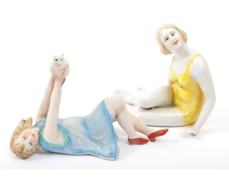 Two 20th Century ceramic Art Deco style figurines. The lot to include a seated figure of a lady in a bathing suit and a bisqu