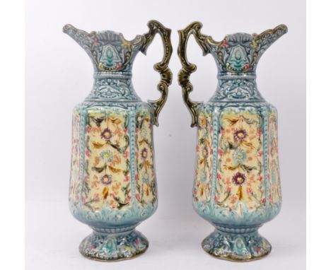 A pair of mid 20th century circa 1940s ceramic Staffordshire pottery single handled jugs. Each jug having a shaped handle wit