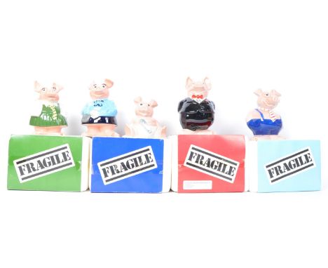 A set of five original Wade made Natwest pigs. Four of the ceramic money boxes within the original packaging.
