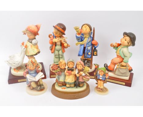 A collection of vintage 20th century Goebel Hummel German boxed figurines to include Little Fidd, Whats New, Apple Tree Boy, 