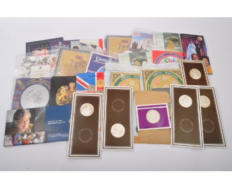 An assortment of vintage 20th century commemorative uncirculated coins sets. The lot to include a 1982, 1984, 1986, two 1990 