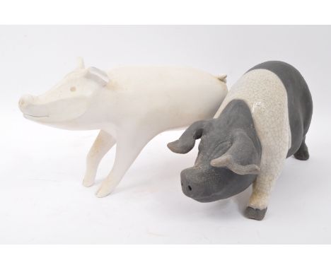 A large porcelain pig figure in the manner of Jonathon Adler with white ground unsigned. Together with another bisque type fi