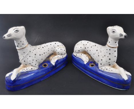 A pair of 19th century Victorian Staffordshire Dalmatians dog figures sitting upon cobalt plinth bases. Measures approx 16cm 