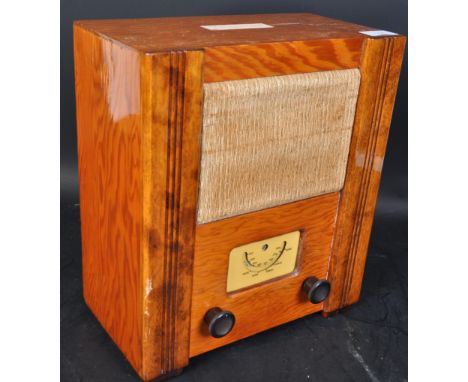 A WWII World War Two circa. 1950's wartime civilian receiver. Issued by the B.T.H Co. The radio being within a walnut veneer 