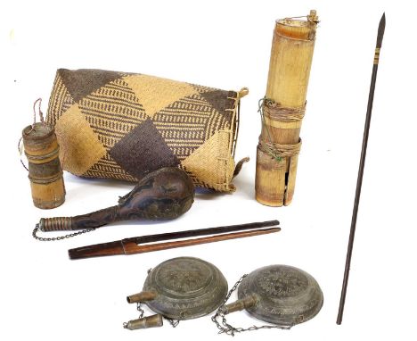 An Indonesian Sumpitan (Blowpipe), the bored-out wood haft set with a spearhead bound with wicker, together with a bamboo qui