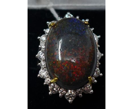 A boxed 18ct white gold natural black opal and brilliant-cut diamond ring, the central oval cabochon opal (13.16 carats) fram