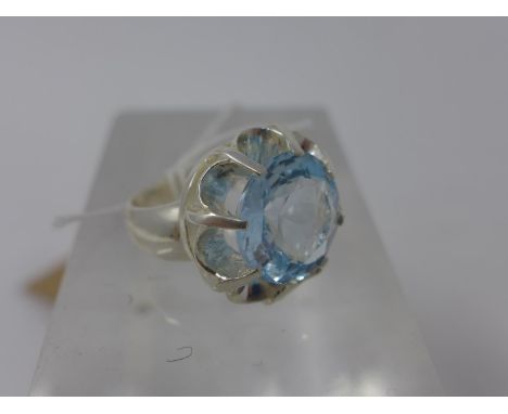 A sterling silver ring centrally set with a circular, faceted round icy-blue topaz, Size: F 1/2, 17g, topaz dia: 13mm 