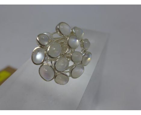 A sterling silver cluster ring set with 14 oval cabochon moonstones within a wire-work mount, Size: Q, 13g 