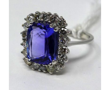 An 18ct white gold brilliant cut diamond and tanzanite ring, Size: N, 5.2 g. Central tanzanite: 11 x 9mm 