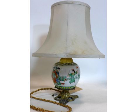 A small Chinese vase converted to a lamp, with gilt metal scrolling mounts, decorated with continuous scene of warriors in a 