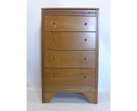 An oak chest of four drawers, the hinged top with fitted mirror to interior, raised on four bracket feet, H.104 W.42 D.62cm 
