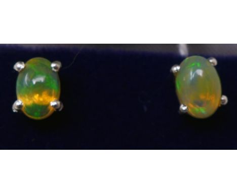 A boxed pair of sterling silver and opal cabochon stud earrings - hues of green, pink and orange 