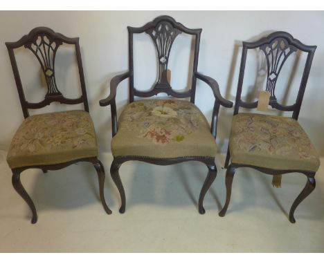 Three Edwardian mahogany dining chairs with tapestry seats 