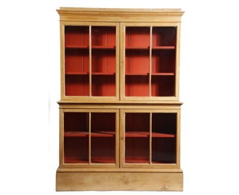 A Victorian pine display cabinet, the top with a pair of astragal gazed doors enclosing a red painted interior with two adjus