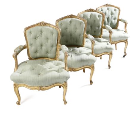 A set of four Louis Philippe giltwood fauteuils in Louis XV style, each with moulded frames carved with leaves and flowers, w