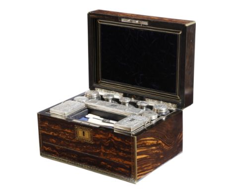 λ A Victorian coromandel dressing case, with brass mounts, the hinged lid with an engraved plaque with a monogram and a date 