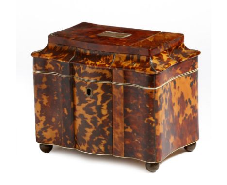 λ A late Regency tortoiseshell sarcophagus tea caddy, with pewter stringing, the hinged top with a silver coloured metal vaca