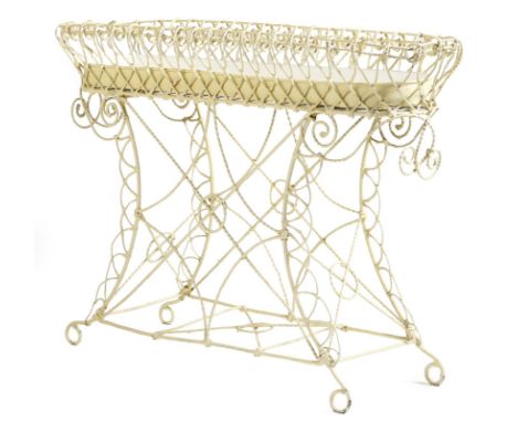 A cream painted wirework planter, with an oblong tray, on scroll supports, 76.5cm high, 107cm wide, 31cm deep.Click here to v