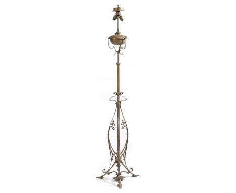 An Art Nouveau brass and copper standard lamp, with two lights, with open scroll decoration, 176.5cm high, 45cm wide.Click he