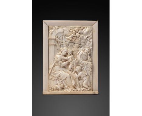 λ A late 17th century South German ivory relief plaque in the manner of Balthasar Permoser, depicting the Holy family with St