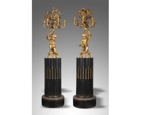 A pair of large and impressive Napoleon III ormolu figural twelve-light candelabra attributed to Raingo Freres, each modelled