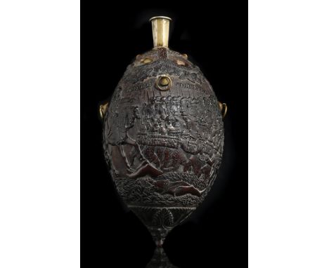 A 19th century French carved coconut bugbear flask, with brass mounts, relief decorated with the battle of Solferino and depi