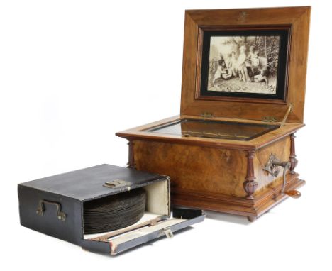A late 19th century German walnut symphonion by Schutz-Marke, the hinged lid inlaid with marquetry flowers and leaves, the un