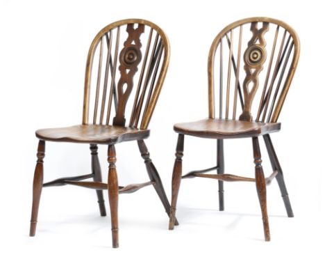 Two similar fruitwood and ash hoop back Windsor chairs, each with a pierced and rondel splat back, above an elm seat, on turn