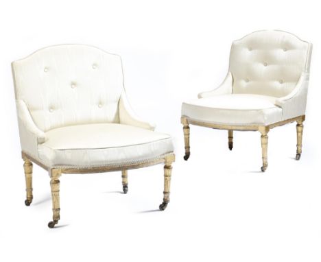 A pair of early 19th century giltwood parlour chairs, each with an arched back, button upholstered with ivory watered silk, o