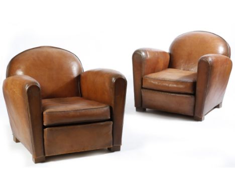 A pair of Art Deco style brown leather easy armchairs, first half of 20th century. (2)Click here to view the online page turn