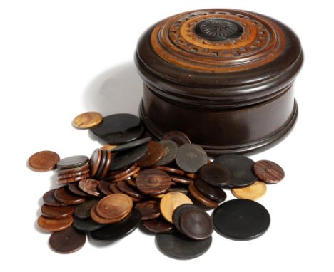 A Victorian engine turned ebony box and cover, containing a large quantity of treen counters, in various woods, the underside