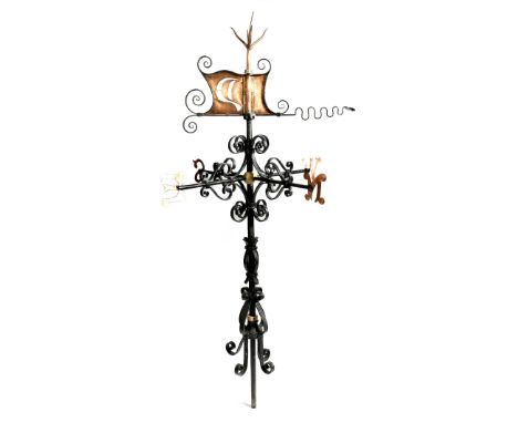 A Victorian wrought iron and copper weather vane, with a coral finial above a sail, decorated with scrolls and with the point