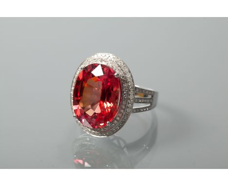 LARGE RED SAPPHIRE AND DIAMOND CLUSTER RING
the central oval cut red sapphire of approximately 13 carats, surrounded by appro