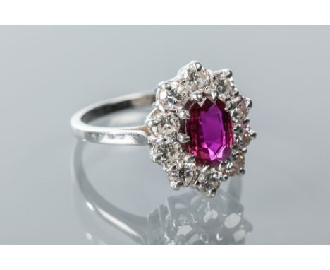 FINE RUBY AND DIAMOND CLUSTER RING
the central oval ruby of approximately 1 carat, surrounded by brilliant cut diamonds total