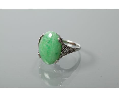 JADEITE AND DIAMOND DRESS RING
the large oval cabochon jade measuring approximately 16.2mm x 11.9mm x 3.3mm, on diamond set s