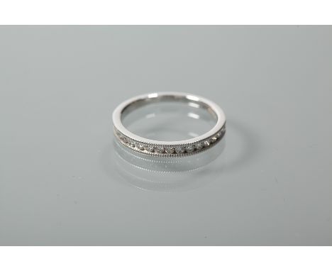 DIAMOND SET HALF ETERNITY RING
with channel set brilliant cut stones, in eighteen carat white gold, size M