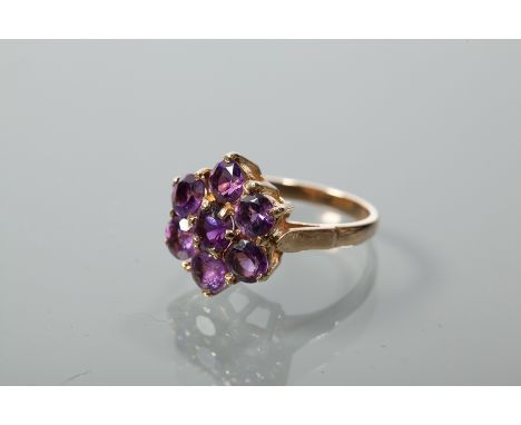 NINE CARAT GOLD AMETHYST DAISY CLUSTER RING
set with a cluster of amethysts totalling approximately 1.5 carats, hallmarked ni