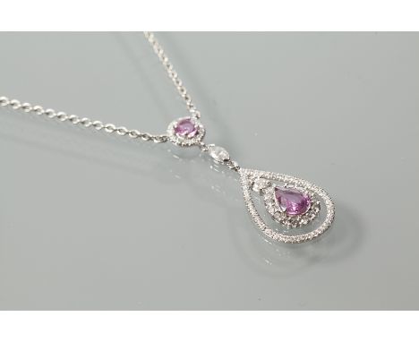 PINK SAPPHIRE AND DIAMOND SET CLUSTER PENDANT
with a pear cut pink sapphire surrounded by brilliant cut diamonds, suspended f