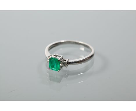 ATTRACTIVE ART DECO STYLE EMERALD AND DIAMOND RING
the central emerald cut emerald of approximately 0.79 carats, flanked by t