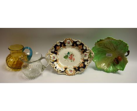 A Victorian cut glass ovoid water jug, engraved with a leafy swag; a Victorian dimpled amber glass jug, blue glass scrolling 